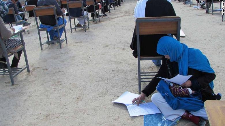 photo Of Afghan Woman Cradling Her Baby While Writing Exam Is Going Viral