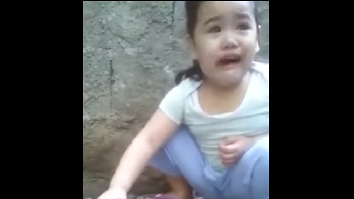 Girl crying over a dead chicken
