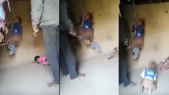 man hangs child on rope and beat