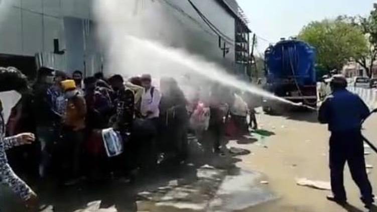 delhi disinfectant sprayed on migrant workers