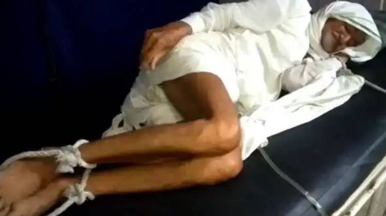 No money to pay bill; elderly man tied up in hospital bed
