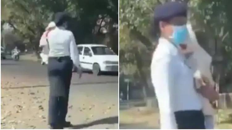 cop controls traffic with baby in her arms viral video