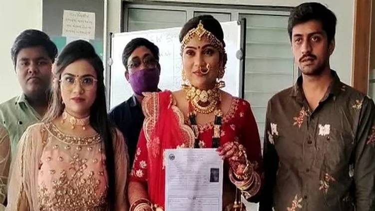 girl writes exam in bridal dress