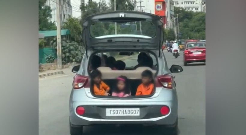 car driving with kids sitting in open boot