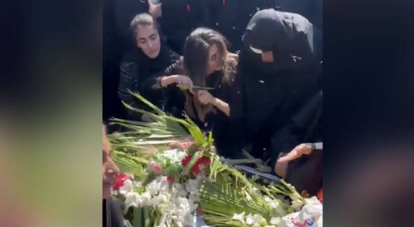 iran woman chop hair on brother grave