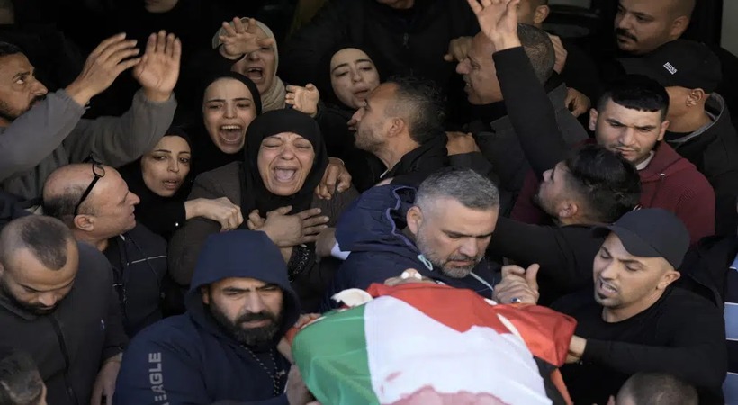 Palestinian teacher shot while giving first aid to militant
