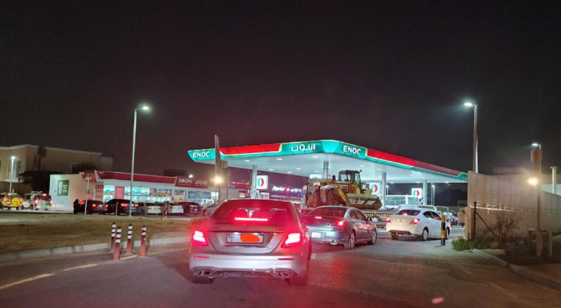 Cars queue up outside gas station