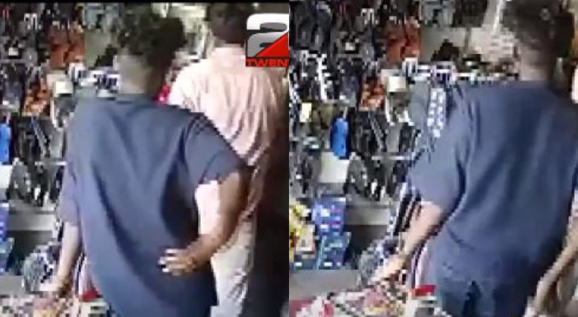 two young men steal money from a shoe shop