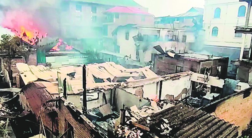 Images of Smoke and flames billow from the abandoned houses of Manipur