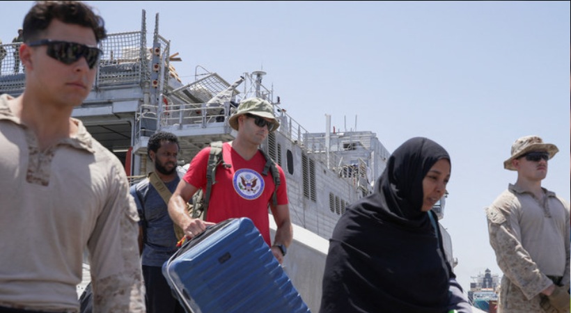 US citizens and other nationalities disembark from the US Navy fast transport ship, the USNS Brunswick, which arrived in Saudi Arabia from Sudan on May 1, 2023.