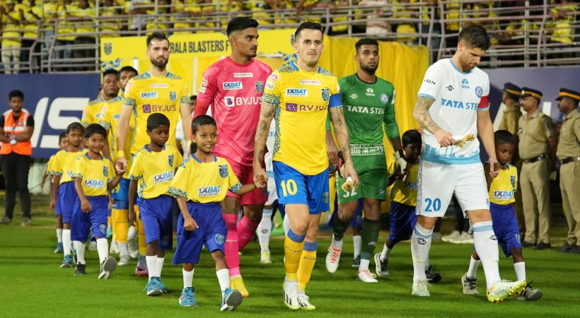 Students from tribal village holding hands with Kerala Blasters
