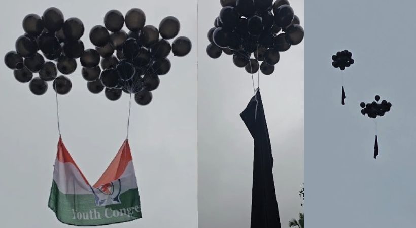 Youth congress protest using black baloons and black flags