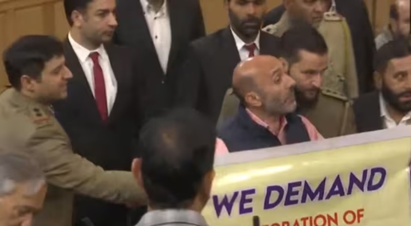 Chaos in J&K assembly as Engineer Rashid's brother shows banner on Article 370